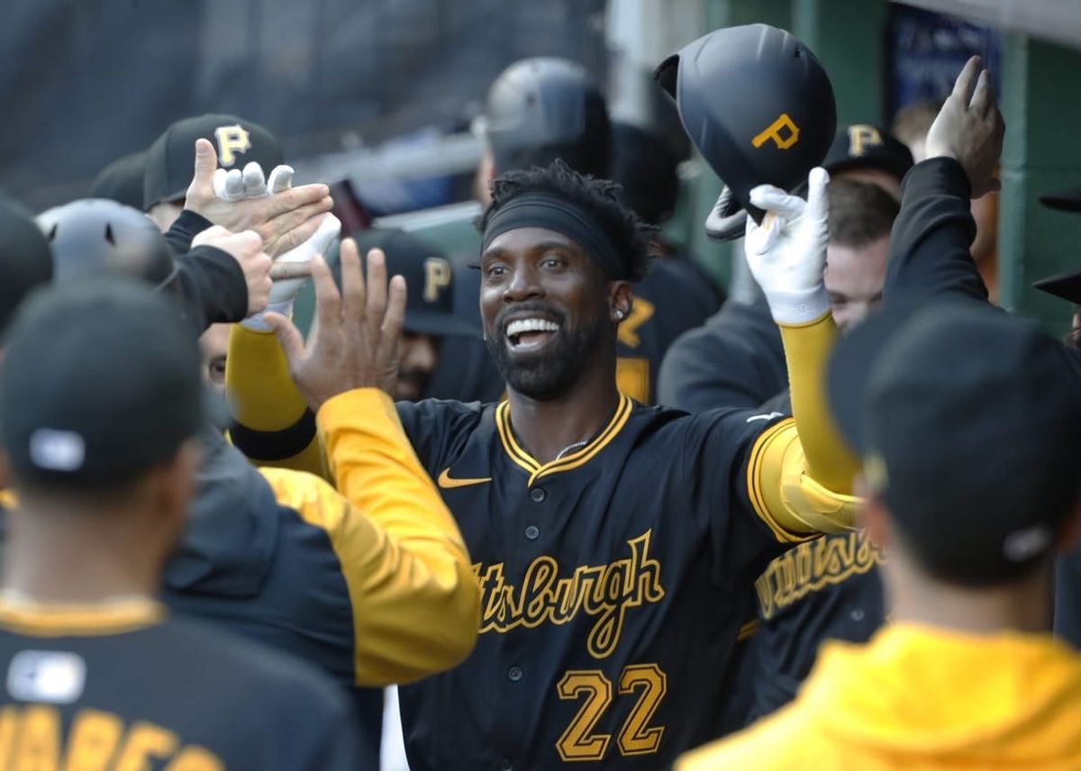 Apr 22, 2024; Pittsburgh, Pennsylvania, USA;  Pittsburgh Pirates designated hitter Andrew McCutchen (22) celebrates his solo home run in the dugout against the Milwaukee Brewers during the first inning at PNC Park.