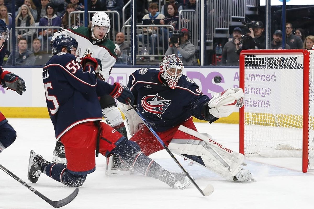 Nov 16, 2023; Columbus, Ohio, USA; Columbus Blue Jackets goalie Elvis Merzlikins (90) deflects the puck over the net as Arizona Coyotes left wing Matias Maccelli (63) awaits a rebound during the first period at Nationwide Arena.