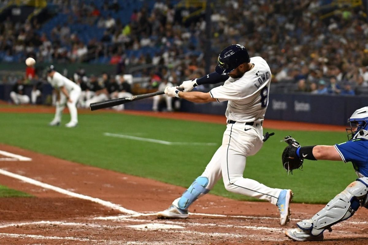 Mar 29, 2024; St. Petersburg, Florida, USA; Tampa Bay Rays second baseman Brandon Lowe (8) hits a grand slam in the third inning of the game against the Toronto Blue Jays  at Tropicana Field.