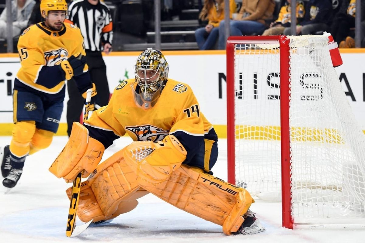 Dec 16, 2023; Nashville, Tennessee, USA; Nashville Predators goaltender Juuse Saros (74) watches a shot deflect into the corner during the second period against the Washington Capitals at Bridgestone Arena.