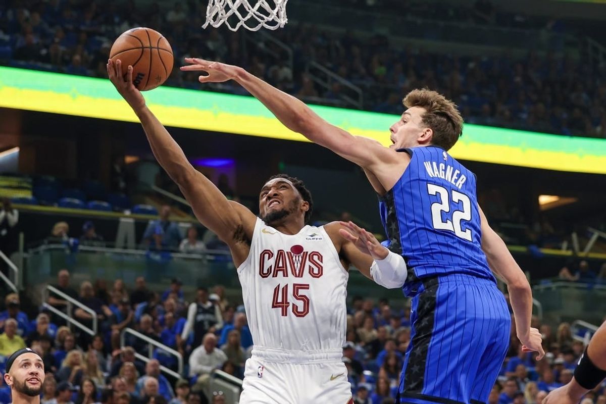 May 3, 2024; Orlando, Florida, USA; Orlando Magic forward Franz Wagner (22) blocks a shot by Cleveland Cavaliers guard Donovan Mitchell (45) during the first quarter of game six of the first round for the 2024 NBA playoffs at Kia Center.