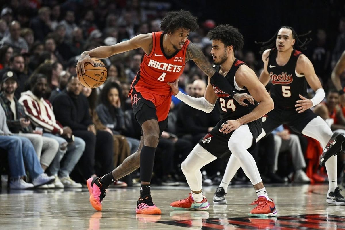 Apr 12, 2024; Portland, Oregon, USA; Houston Rockets guard Jalen Green (4) dribbles the ball during the second half against Portland Trail Blazers forward Justin Minaya (24) at Moda Center.
