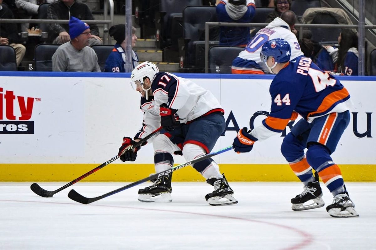 Dec 7, 2023; Elmont, New York, USA; Columbus Blue Jackets right wing Justin Danforth (17) skates past New York Islanders center Jean-Gabriel Pageau (44) during the first period at UBS Arena.