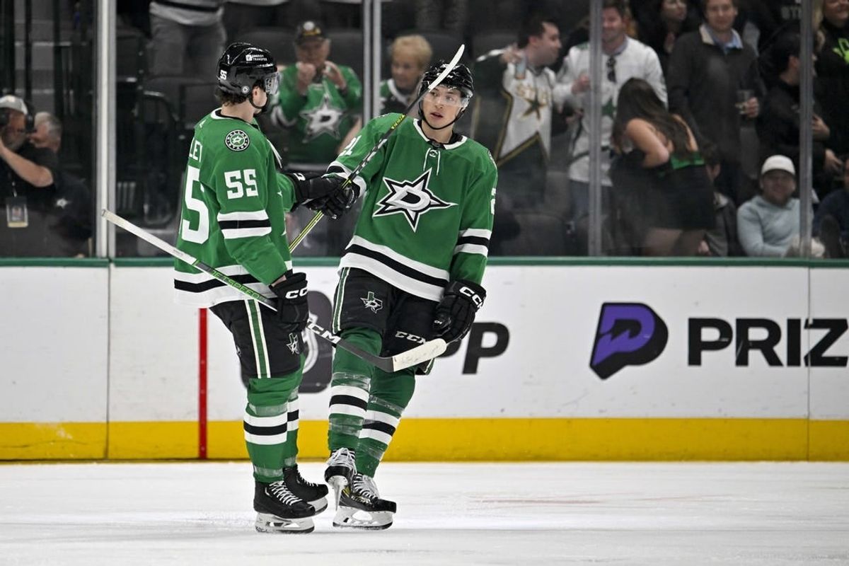 Mar 20, 2024; Dallas, Texas, USA; Dallas Stars defenseman Thomas Harley (55) and left wing Jason Robertson (21) celebrates a goal scored by Robertson against the Arizona Coyotes during the third period at the American Airlines Center.