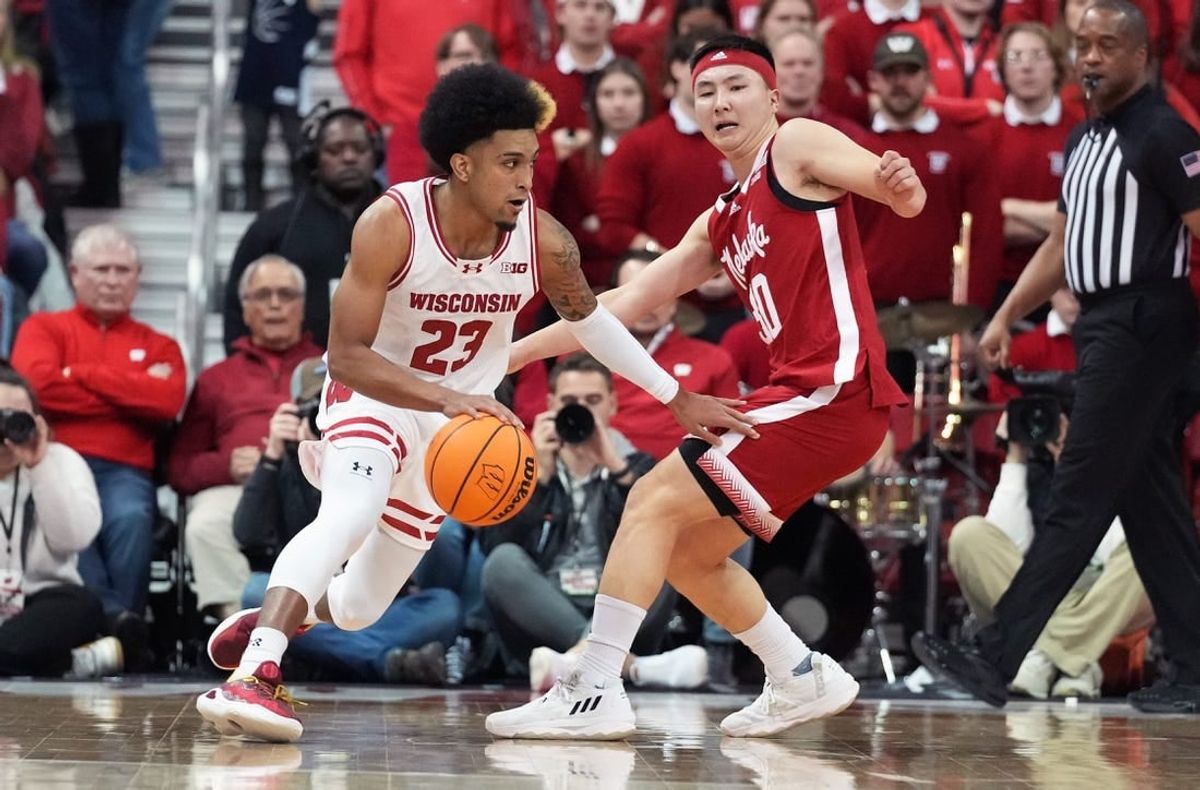 Jan 6, 2024; Madison, Wisconsin, USA; Wisconsin Badgers guard Chucky Hepburn (23) dribbles the ball against Nebraska Cornhuskers guard Keisei Tominaga (30) during the first half at the Kohl Center.