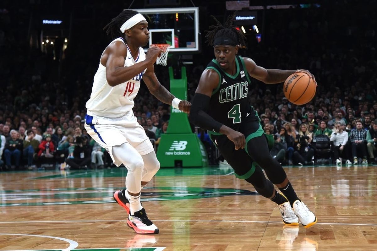 Jan 27, 2024; Boston, Massachusetts, USA;  Boston Celtics guard Jrue Holiday (4) controls the ball while LA Clippers guard Terance Mann (14) defends during the second half at TD Garden.