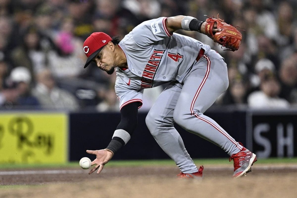 Apr 29, 2024; San Diego, California, USA; Cincinnati Reds third baseman Santiago Espinal (4) fields a ground ball bare-handed during the seventh inning against the San Diego Padres at Petco Park.
