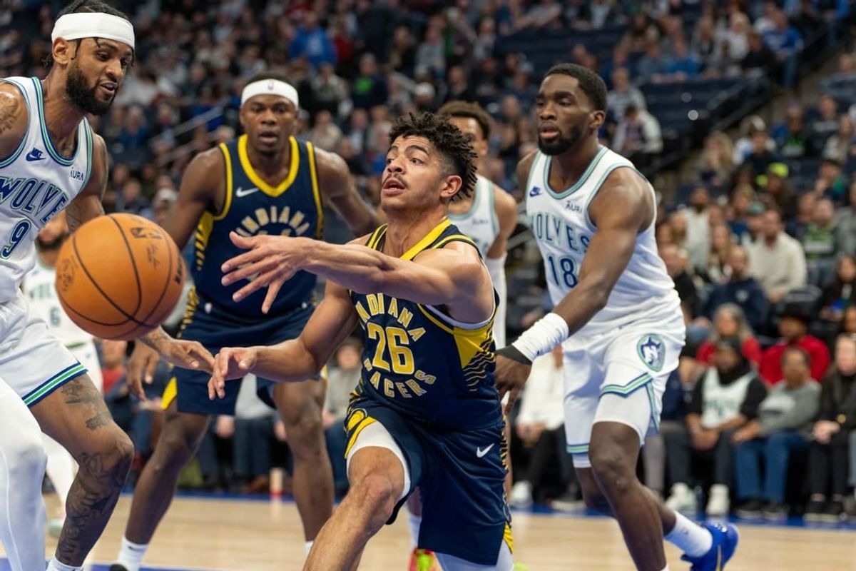 Dec 16, 2023; Minneapolis, Minnesota, USA; Indiana Pacers guard Ben Sheppard (26) passes the ball while defended by Minnesota Timberwolves guard Nickeil Alexander-Walker (9) in the fourth quarter at Target Center.