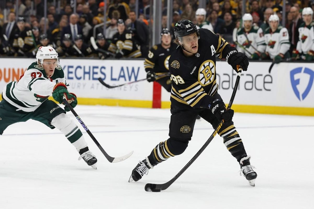Dec 19, 2023; Boston, Massachusetts, USA; Boston Bruins right wing David Pastrnak (88) lets go with a shot in front of Minnesota Wild left wing Kirill Kaprizov (97) during the first period at TD Garden.