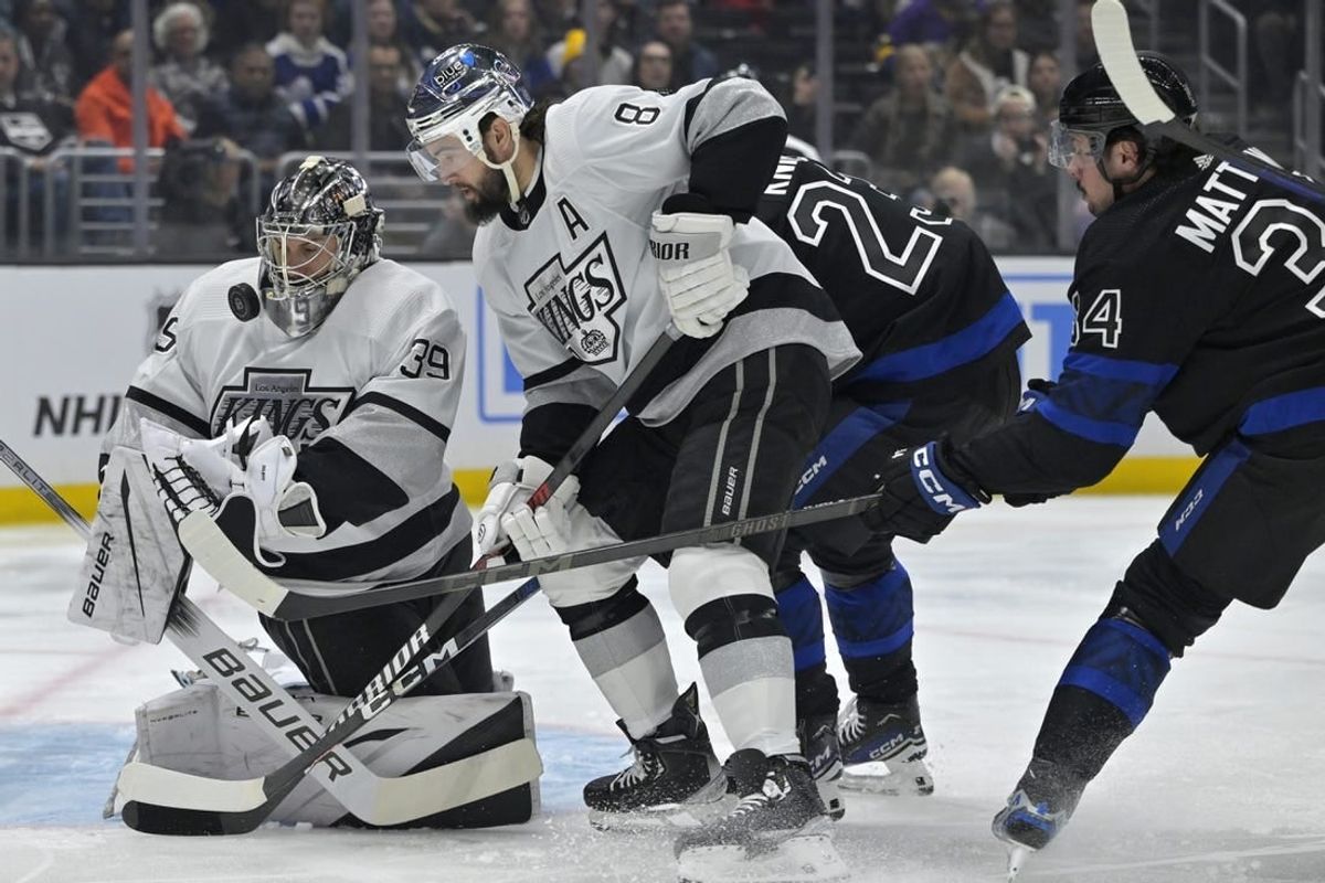 Jan 2, 2024; Los Angeles, California, USA; Los Angeles Kings goaltender Cam Talbot (39) makes a save off a shot by Toronto Maple Leafs left wing Matthew Knies (23) as Los Angeles Kings defenseman Drew Doughty (8) defends in the first period at Crypto.com Arena.
