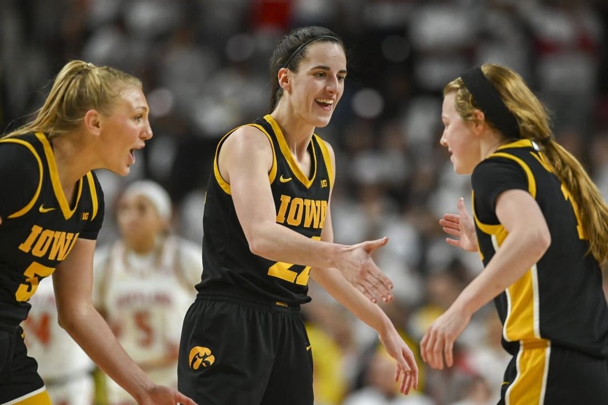 Feb 3, 2024; College Park, Maryland, USA;  Iowa Hawkeyes guard Caitlin Clark (22) celebrates with  guard Sydney Affolter (3) and  guard Molly Davis (1) during the second half against the Maryland Terrapins at Xfinity Center.
