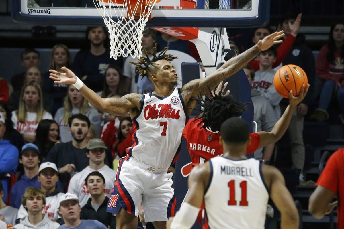 Nov 28, 2023; Oxford, Mississippi, USA; Mississippi Rebels guard Allen Flanigan (7) blocks the shot of North Carolina State Wolfpack guard Dennis Parker, Jr. (11) during the second half at The Sandy and John Black Pavilion at Ole Miss.