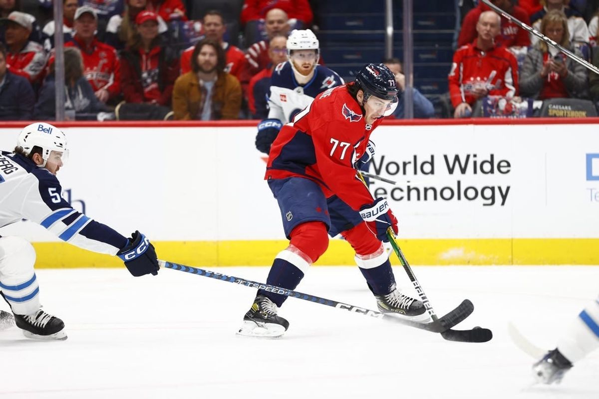 Mar 24, 2024; Washington, District of Columbia, USA; Washington Capitals right wing T.J. Oshie (77) controls the puck as Winnipeg Jets defenseman Dylan Samberg (54) defends during the first period at Capital One Arena.