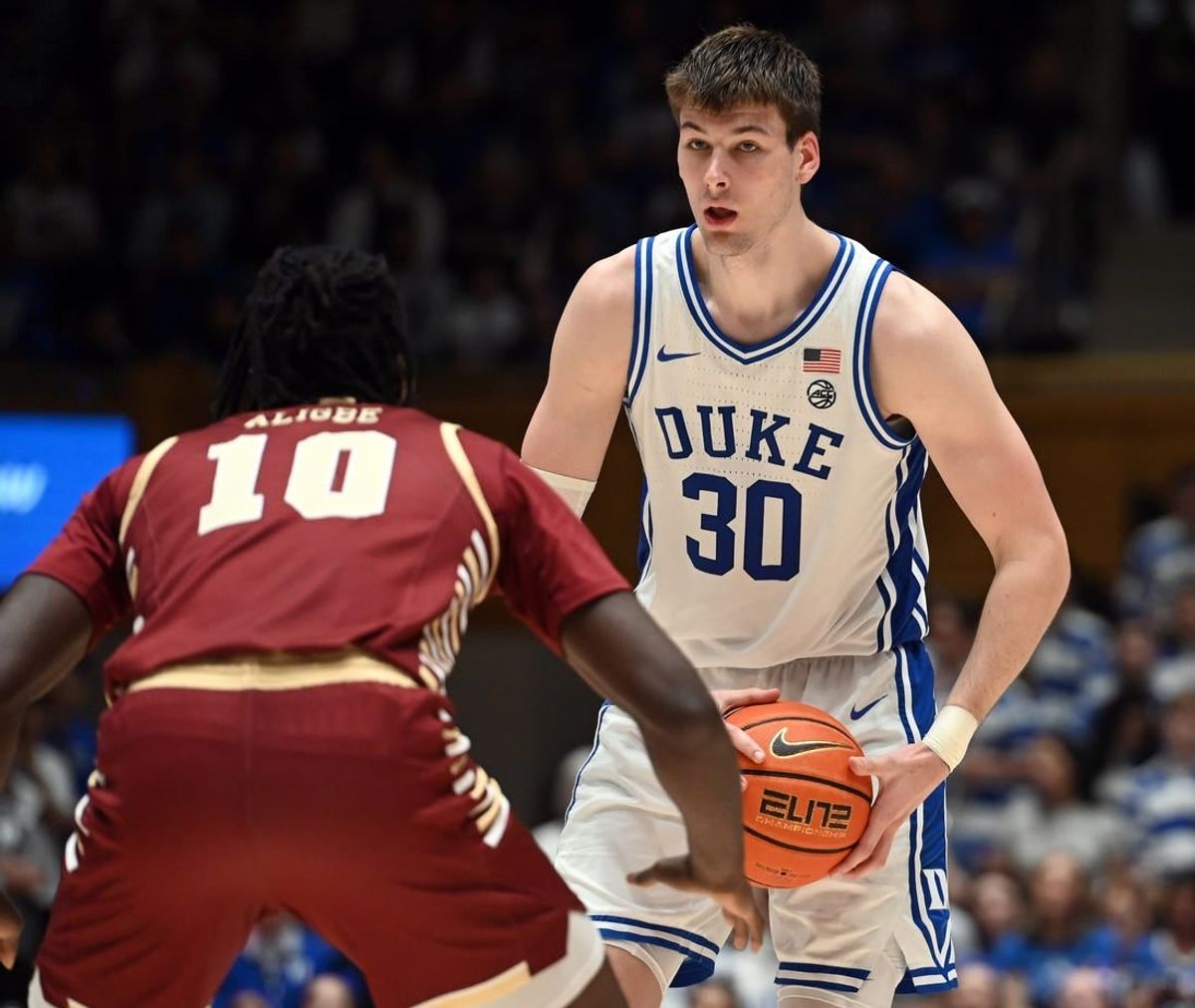Feb 10, 2024; Durham, North Carolina, USA; Duke Blue Devils center Kyle Filipowski (30) controls the ball in front of Boston College Eagles forward Prince Aligbe (10) during the second half at Cameron Indoor Stadium.