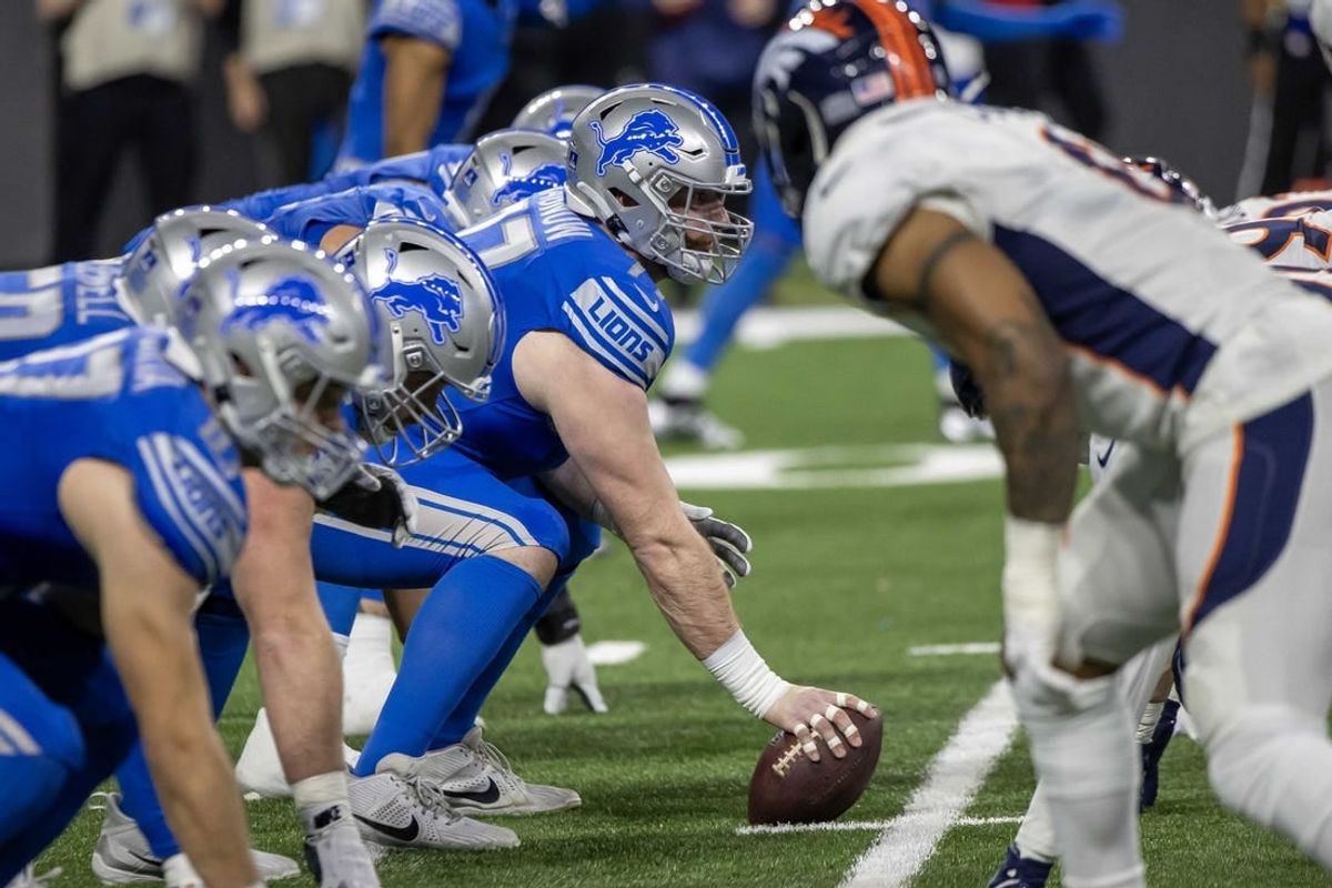 Dec 16, 2023; Detroit, Michigan, USA; Detroit Lions center Frank Ragnow (77) gets ready to snap the ball in the first half against the Denver Broncos at Ford Field.