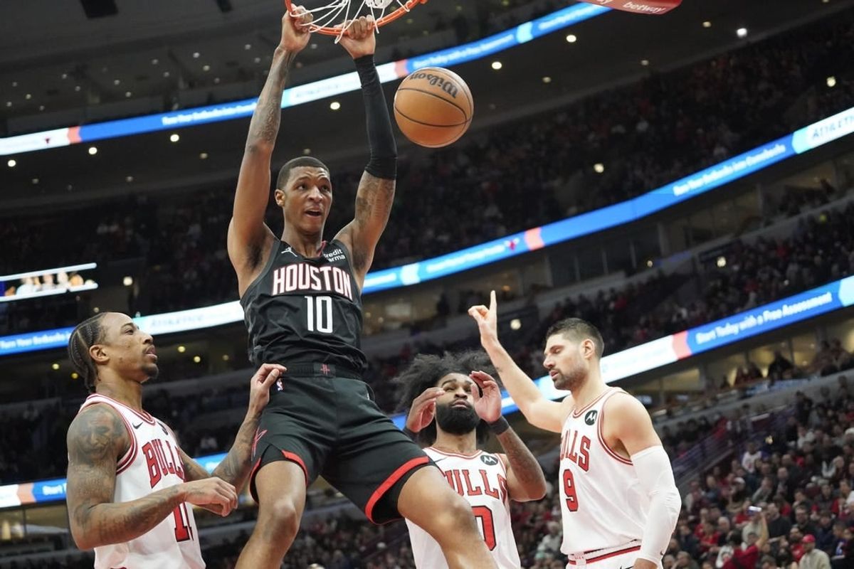 Jan 10, 2024; Chicago, Illinois, USA; Houston Rockets forward Jabari Smith Jr. (10) dunks the ball on Chicago Bulls forward DeMar DeRozan (11) during the first quarter at United Center.