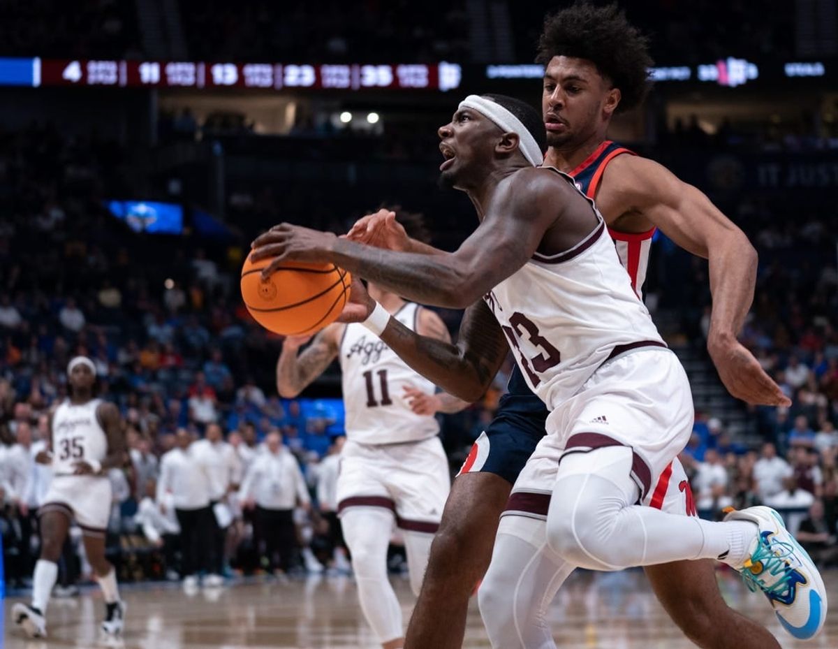 Texas A&M Aggies guard Tyrece Radford (23) drives to the bucket against Mississippi Rebels forward Jaemyn Brakefield (4) during their second round game of the SEC Men's Basketball Tournament at Bridgestone Arena in Nashville, Tenn., Thursday, March 14, 2024.