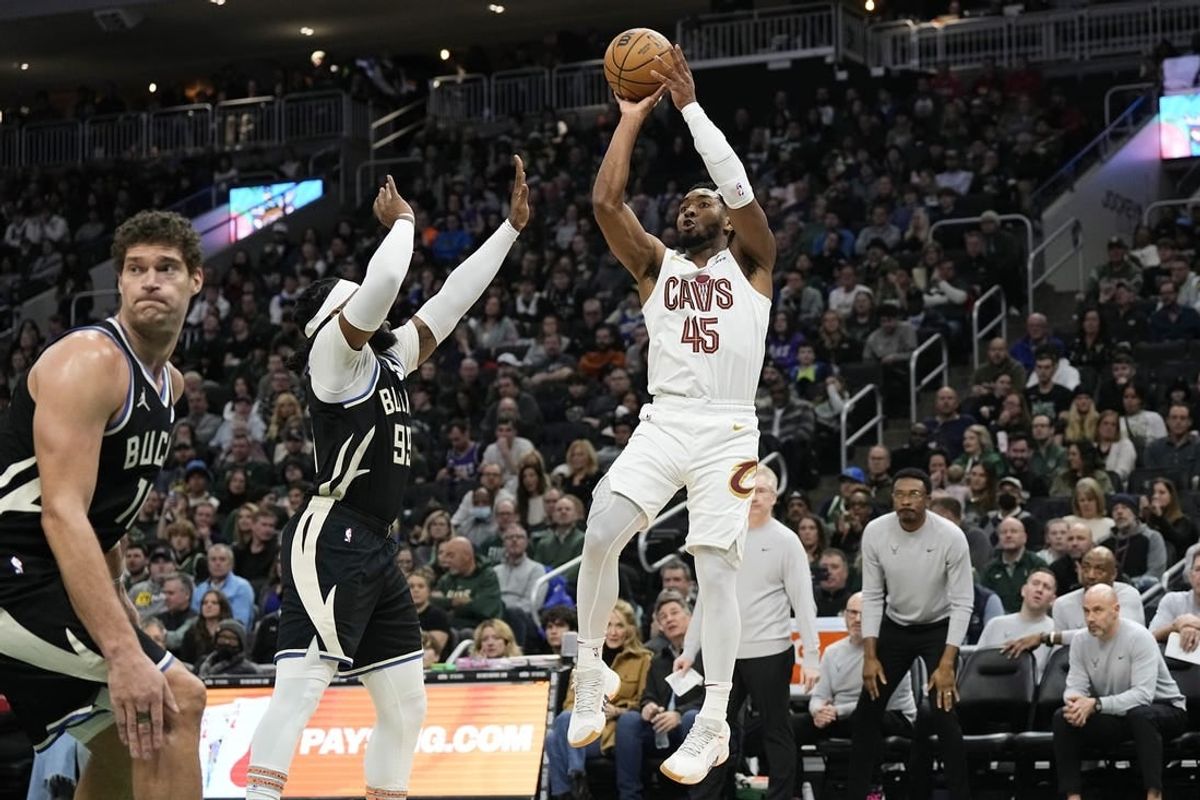 Jan 26, 2024; Milwaukee, Wisconsin, USA;  Cleveland Cavaliers guard Donovan Mitchell (45) shoots against Milwaukee Bucks forward Jae Crowder (99) during the third quarter at Fiserv Forum.