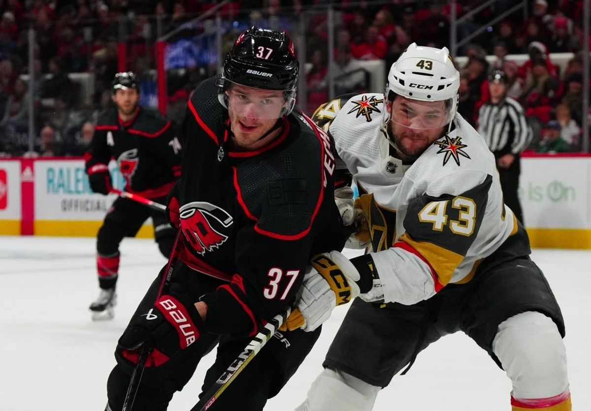 Dec 19, 2023; Raleigh, North Carolina, USA; Carolina Hurricanes right wing Andrei Svechnikov (37) and Vegas Golden Knights center Paul Cotter (43) battle for position during the first period at PNC Arena.