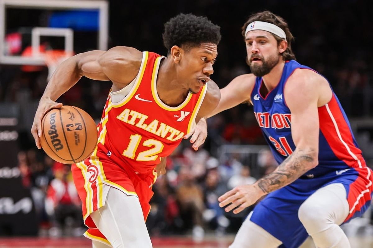 Dec 18, 2023; Atlanta, Georgia, USA; Atlanta Hawks forward De'Andre Hunter (12) drives on Detroit Pistons forward Joe Harris (31) in the second quarter at State Farm Arena.