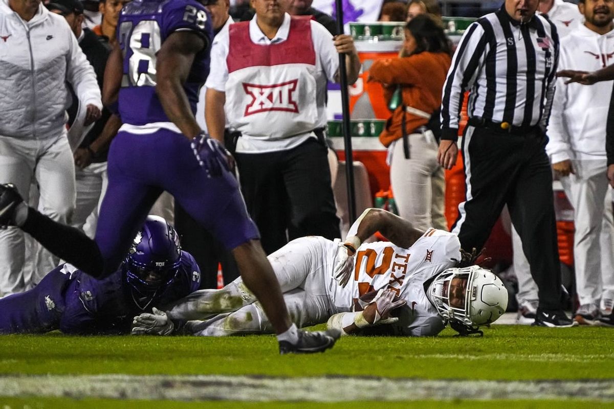 Nov 11, 2023; Fort Worth, Texas, USA; Texas Longhorns running back Jonathon Brooks (24) is brought down by TCU Horned Frogs cornerback Josh Newton (3) during the game at Amon G. Carter Stadium.