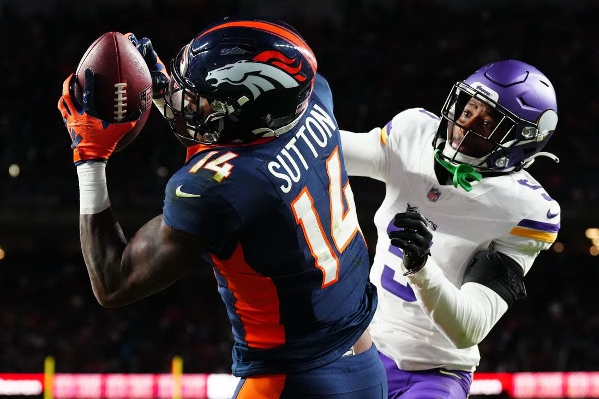 Nov 19, 2023; Denver, Colorado, USA; Denver Broncos wide receiver Courtland Sutton (14) catches a touchdown over Minnesota Vikings cornerback Mekhi Blackmon (5) in the fourth quarter at Empower Field at Mile High.