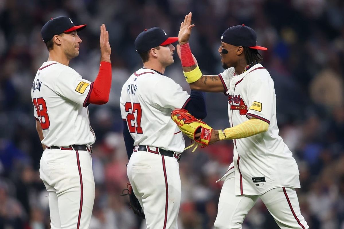 Apr 6, 2024; Atlanta, Georgia, USA; Atlanta Braves first baseman Matt Olson (28) and third baseman Austin Riley (27) and right fielder Ronald Acuna Jr. (13) celebrate after a victory against the Arizona Diamondbacks at Truist Park.