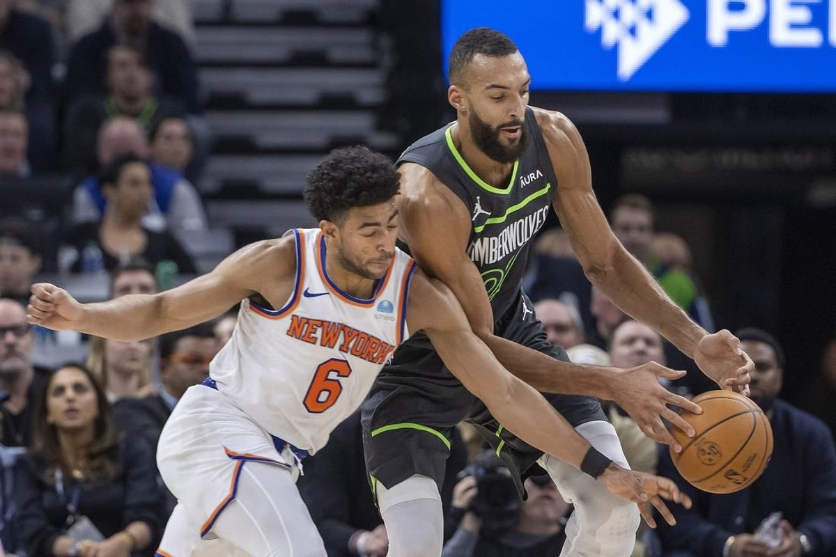 Nov 20, 2023; Minneapolis, Minnesota, USA; New York Knicks guard Quentin Grimes (6) and Minnesota Timberwolves center Rudy Gobert (27) go after a loose ball in the first half at Target Center.