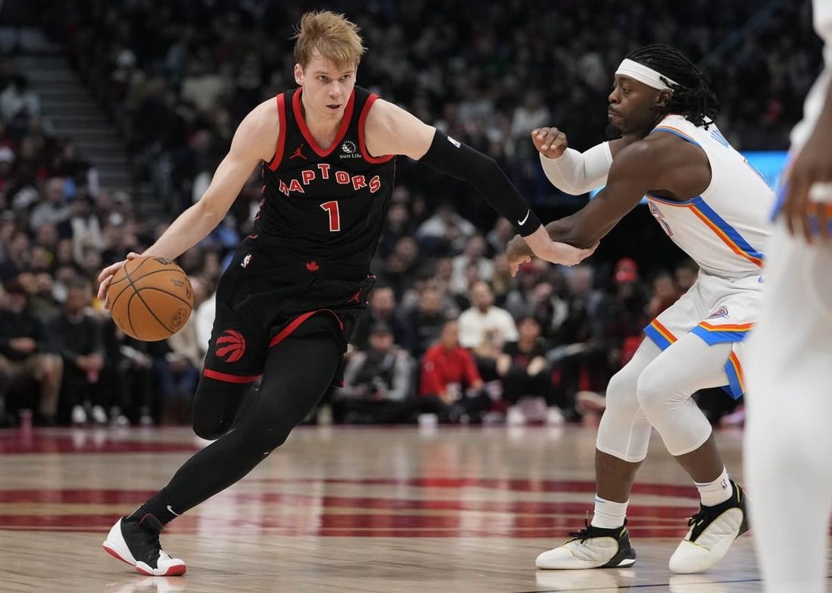 Mar 22, 2024; Toronto, Ontario, CAN; Toronto Raptors guard Gradey Dick (1) drives to the net against Oklahoma City Thunder forward Jalen Williams (8) during the second half at Scotiabank Arena.