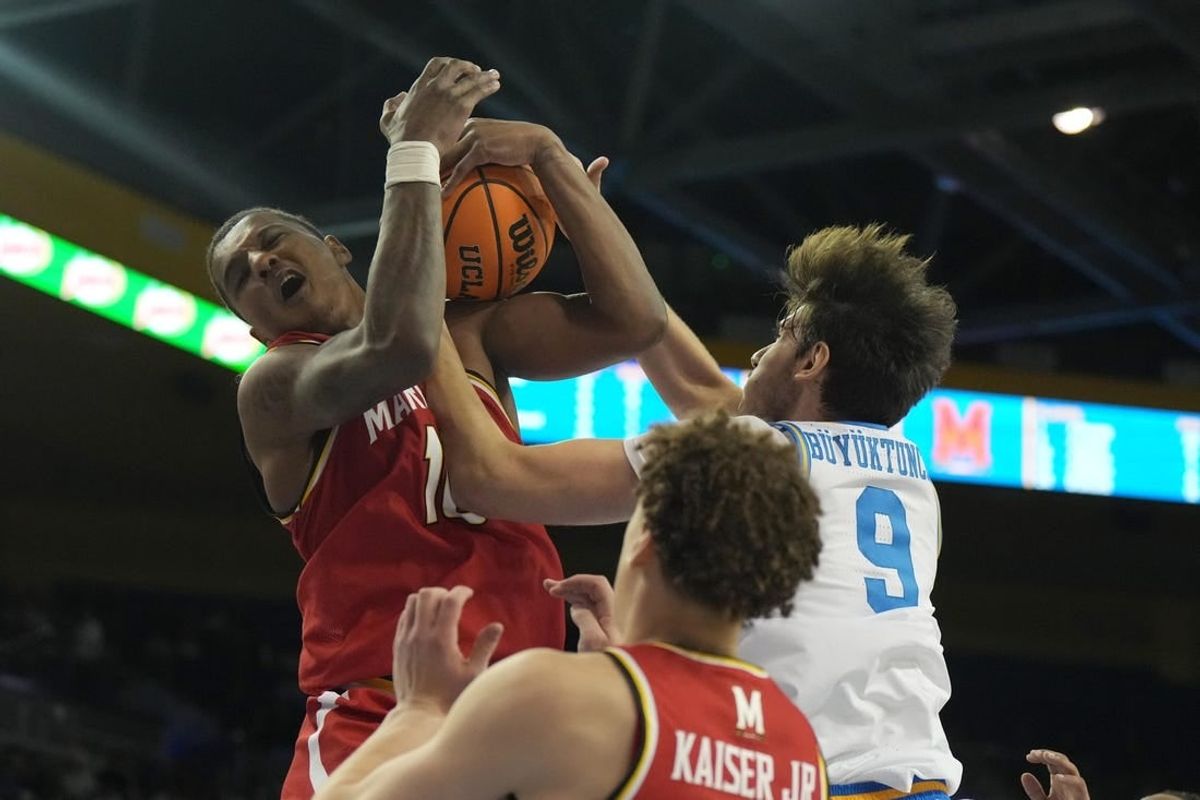 Dec 22, 2023; Los Angeles, California, USA; Maryland Terrapins forward Julian Reese (10) and UCLA Bruins forward Berke Buyuktuncel (9) battle for the ball in the second half at Pauley Pavilion presented by Wescom.