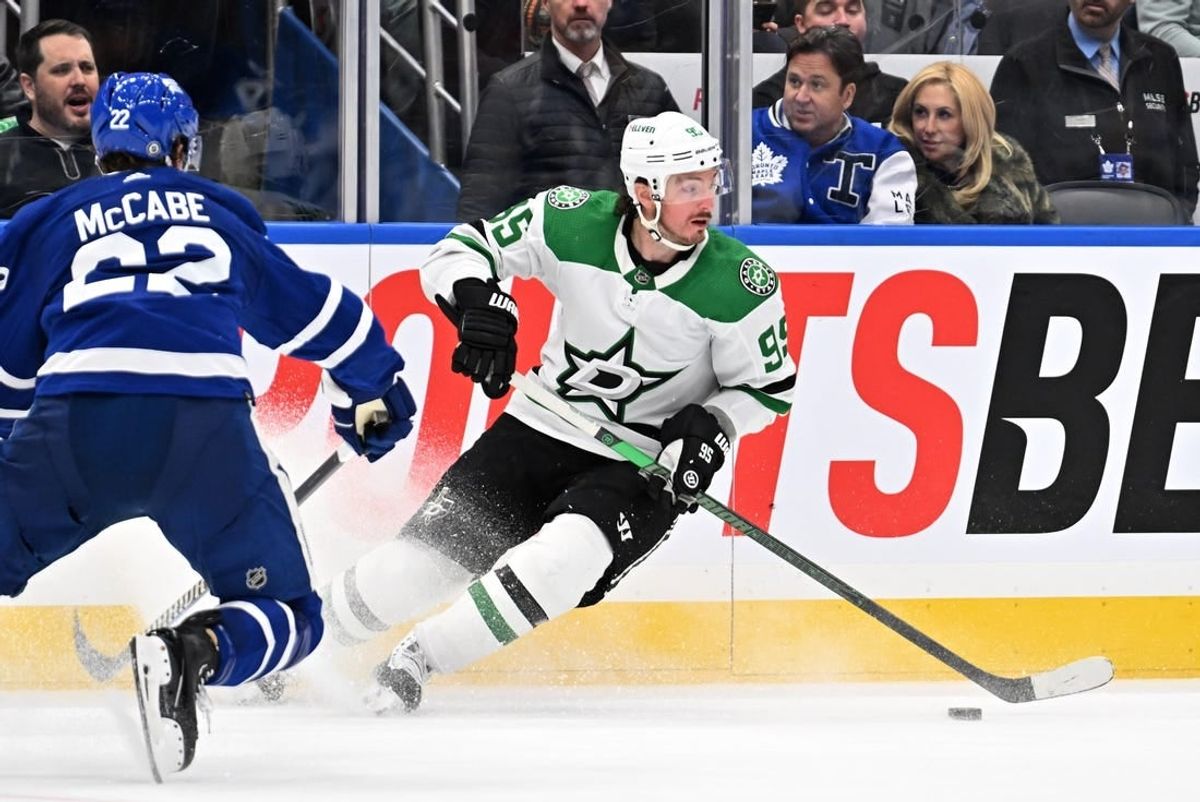 Feb 7, 2024; Toronto, Ontario, CAN; Dallas Stars forward Matt Duchene (95) turns with the puck away from Toronto Maple Leafs defenseman Jake McCabe (22) in the second period at Scotiabank Arena.