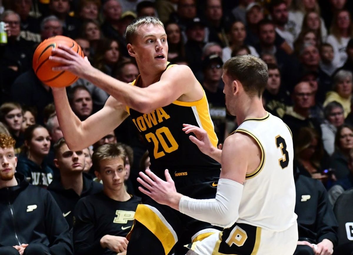 Dec 4, 2023; West Lafayette, Indiana, USA; Iowa Hawkeyes forward Payton Sandfort (20) looks to pass around Purdue Boilermakers guard Braden Smith (3) during the first half at Mackey Arena.