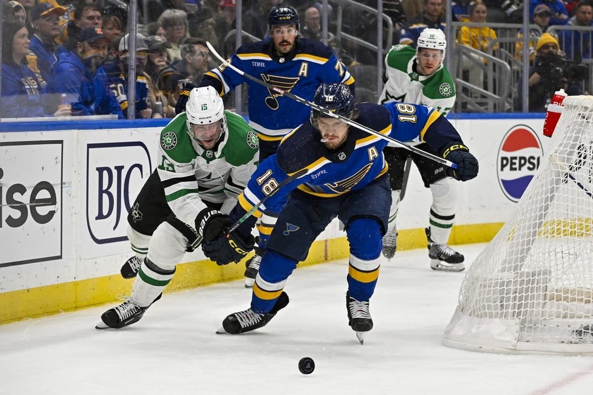 Dec 27, 2023; St. Louis, Missouri, USA;  Dallas Stars center Craig Smith (15) and St. Louis Blues center Robert Thomas (18) battle for the puck during the first period at Enterprise Center.