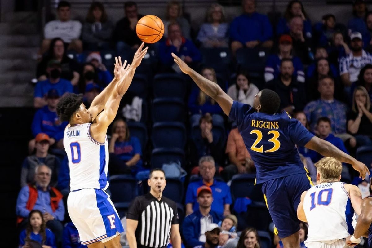 Dec 30, 2023; Gainesville, Florida, USA; Florida Gators guard Zyon Pullin (0) shoots over Quinnipiac Bobcats forward JJ Riggins (23) during the first half at Exactech Arena at the Stephen C. O'Connell Center.