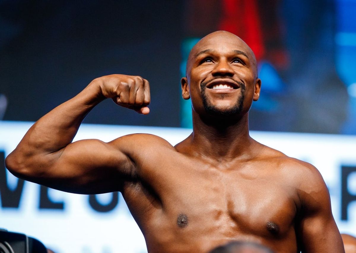 Aug 25, 2017; Las Vegas, NV, USA; Floyd Mayweather flexes as he stands on the scales during weigh ins for the upcoming boxing match at T-Mobile Arena. Mandatory Credit: Mark J. Rebilas-Imagn Images