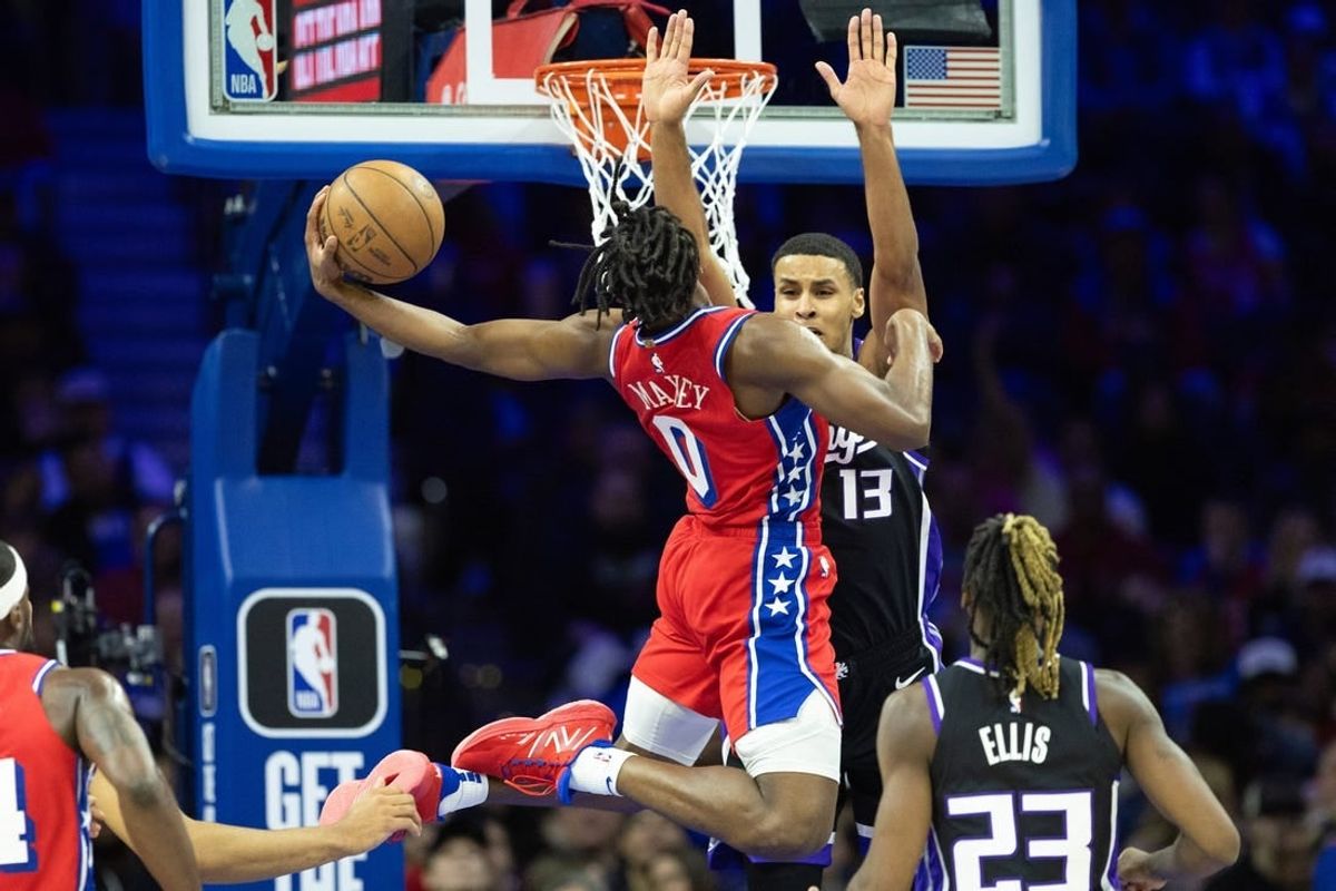 Jan 12, 2024; Philadelphia, Pennsylvania, USA; Philadelphia 76ers guard Tyrese Maxey (0) drives for a score against Sacramento Kings forward Keegan Murray (13) during the second quarter at Wells Fargo Center.