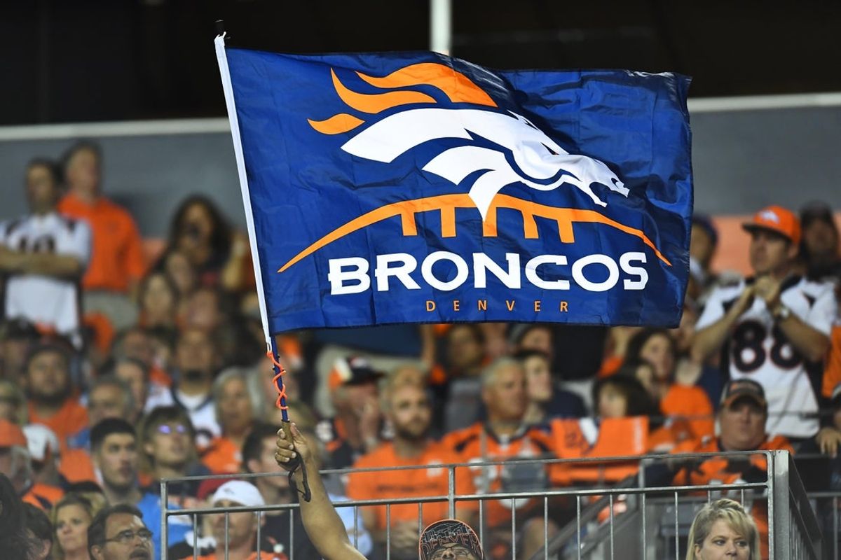Sep 11, 2017; Denver, CO, USA; Denver Broncos fan waves a team logo flag in the second half against the Los Angeles Chargers at Sports Authority Field at Mile High. Mandatory Credit: Ron Chenoy-Imagn Images