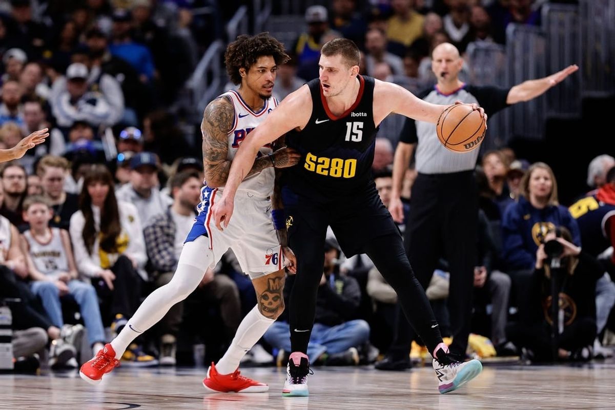 Jan 27, 2024; Denver, Colorado, USA; Denver Nuggets center Nikola Jokic (15) controls the ball as Philadelphia 76ers guard Kelly Oubre Jr. (9) guards in the third quarter at Ball Arena.