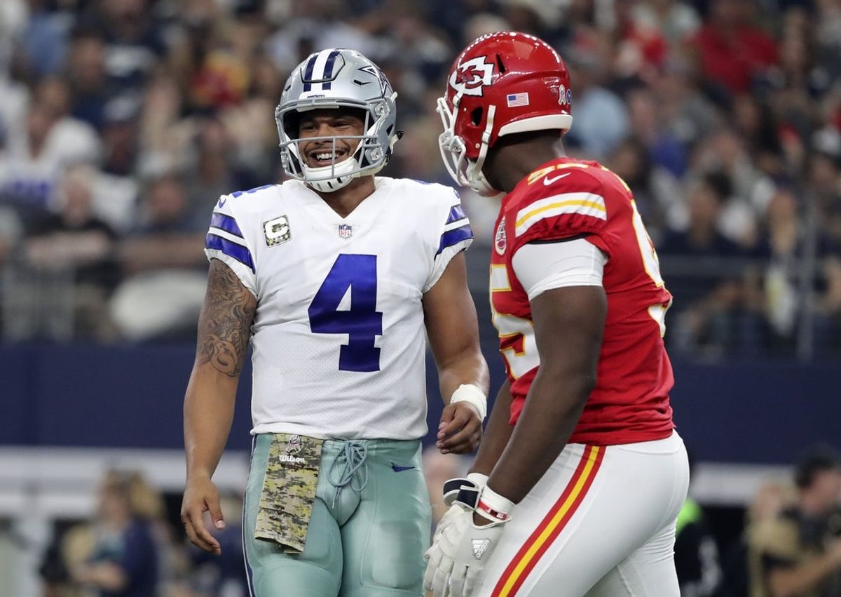 Dallas Cowboys quarterback Dak Prescott (4) laughs with Kansas City Chiefs defensive end Chris Jones (95) during the first half at AT&T Stadium. Mandatory Credit: Kevin Jairaj-Imagn Images