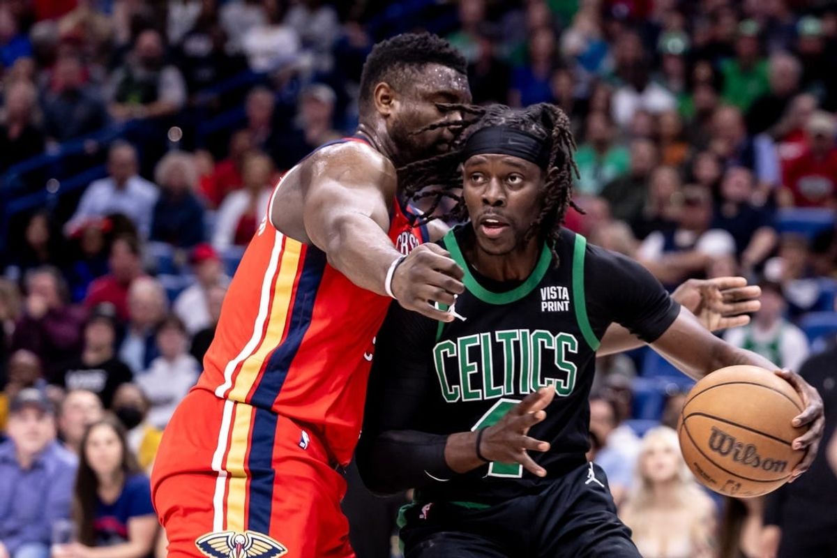 Mar 30, 2024; New Orleans, Louisiana, USA;  Boston Celtics guard Jrue Holiday (4) dribbles against New Orleans Pelicans forward Zion Williamson (1) during the first half at Smoothie King Center.