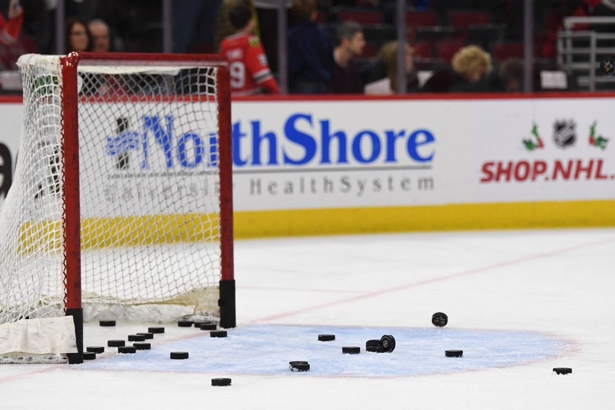 Dec 3, 2017; Chicago, IL, USA; A general view of a hockey net with pucks during warm ups prior to a game between the Los Angeles Kings and the Chicago Blackhawks at the United Center. Mandatory Credit: Patrick Gorski-Imagn Images