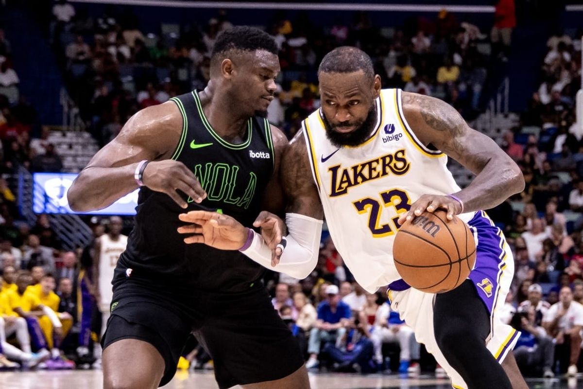 Apr 14, 2024; New Orleans, Louisiana, USA; Los Angeles Lakers forward LeBron James (23) dribbles against New Orleans Pelicans forward Zion Williamson (1) during the second half at Smoothie King Center.