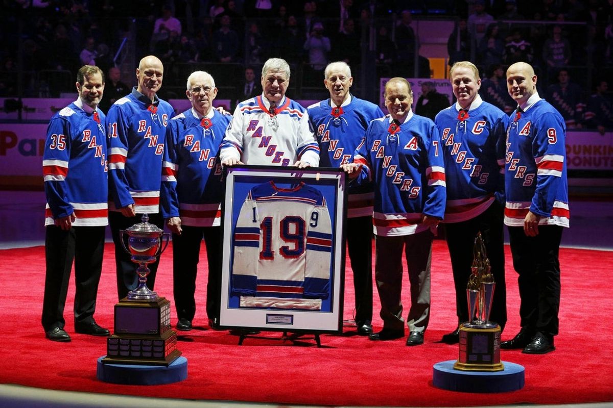 Feb 25, 2018; New York, NY, USA; Former Rangers with retired numbers (left to right) Mike Richter (35) and Mark Messier (11) and Ed Giacomin (1) and Vic Hadfield (11) and Jean Ratelle (19) and Rod Gilbert (7) and Brian Leetch (2) and Adam Graves (9) pose for a photo during a banner raising ceremony for former Ranger star Jean Ratelle before a game between the New York Rangers and Detroit Red Wings at Madison Square Garden. Mandatory Credit: Brad Penner-Imagn Images
