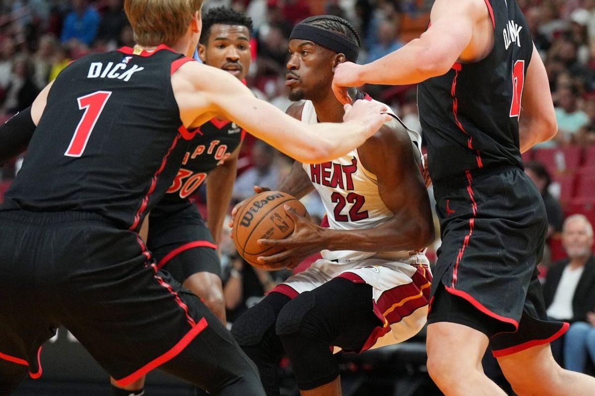 Apr 14, 2024; Miami, Florida, USA;  Miami Heat forward Jimmy Butler (22) gets surrounded by the Toronto Raptors defense during the first half at Kaseya Center.
