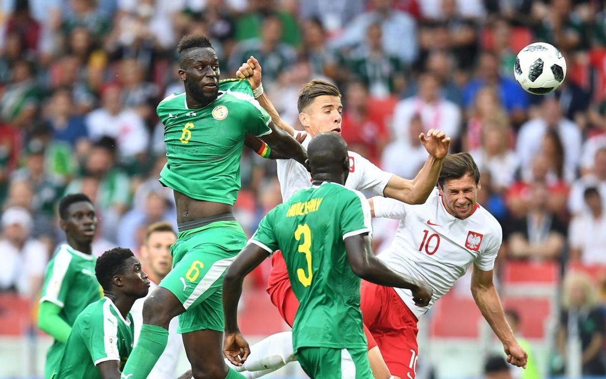 Jun 19, 2018; Moscow, Russia; Poland midfielder Grzegorz Krychowiak (10) heads the ball for a goal past Senegal defender Salif Sane (6) and defender Kalidou Koulibaly (3)  in Group H play during the FIFA World Cup 2018 at Spartak Stadium. Mandatory Credit: Tim Groothuis/Witters Sport via Imagn Images