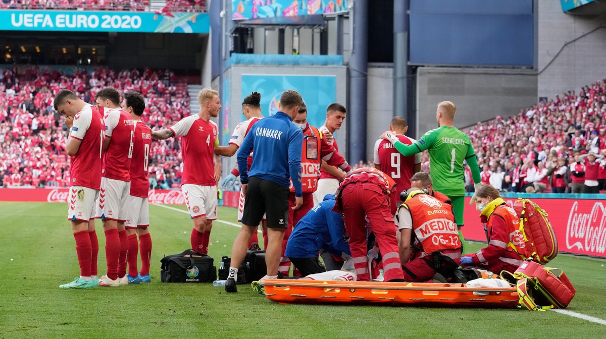 Trainers and medics work on Denmark’s Christian Eriksen after he collapsed on the pitch during Saturday’s match with Finland.