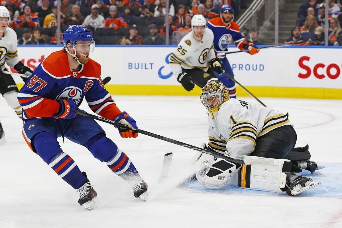 Feb 21, 2024; Edmonton, Alberta, CAN; Boston Bruins goaltender Jeremy Swayman (1) makes a save on  on Edmonton Oilers forward Connor McDavid (97) during the third period at Rogers Place.