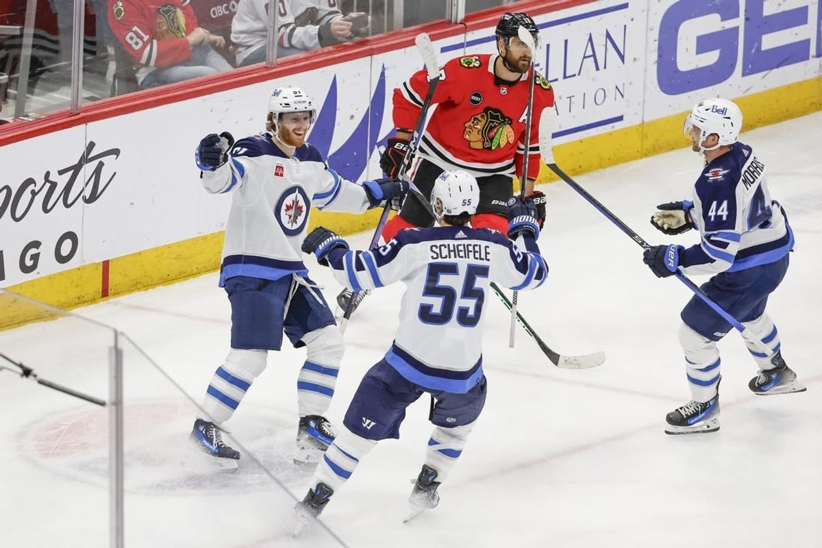 Feb 23, 2024; Chicago, Illinois, USA; Winnipeg Jets left wing Kyle Connor (81) celebrates with teammates after scoring a game winning goal against the Chicago Blackhawks during overtime at United Center.