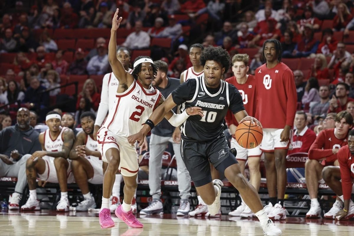 Dec 5, 2023; Norman, Oklahoma, USA; Providence Friars forward Rich Barron (10) drives against Oklahoma Sooners guard Javian McCollum (2) during the first half at Lloyd Noble Center.