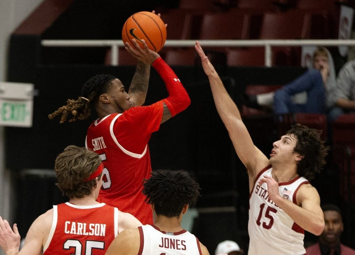 Jan 14, 2024; Stanford, California, USA; Utah Utes guard Deivon Smith (5) shoots over Stanford Cardinal guard Benny Gealer (15) during the second half at Maples Pavilion.
